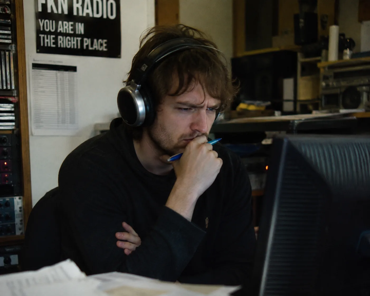 FKN Radio artistic director listening before broadcast